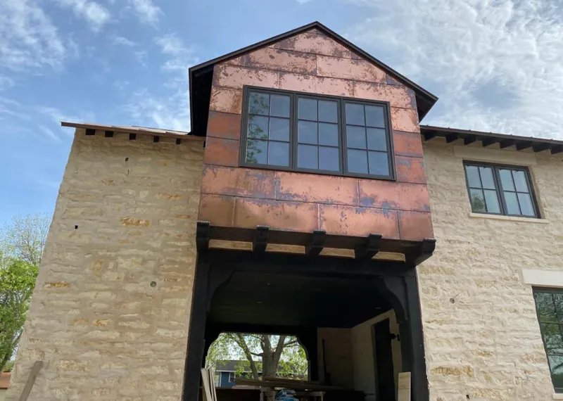 Copper metal panel facade on a stone building for Skylight Installation in Conyers